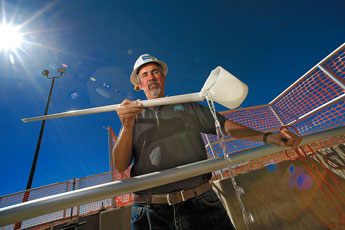 Dennis Wing pours a sample of treated water taken at water treatment plant in Gallup on Wednesday. "This is a lot different than it looks when it gets here," Wing said. © 2011 Gallup Independent / Adron Gardner 